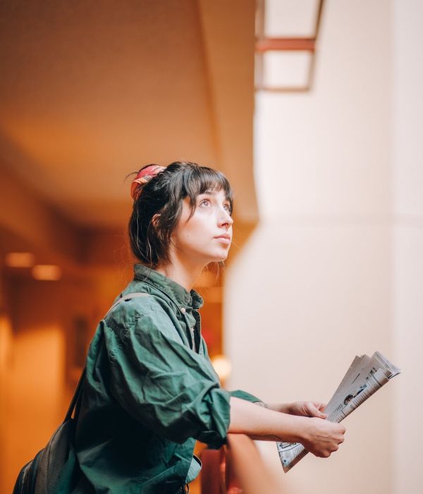 Woman in a calm indoor space performing a low-impact cardio movement with focus.